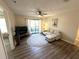 Living room with hardwood flooring, ceiling fan, and sliding glass door to outside patio at 4005 Crockers Lake Blvd # 11, Sarasota, FL 34238