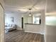 Open living room view looking into the kitchen with light gray sofa and hardwood flooring throughout at 4005 Crockers Lake Blvd # 11, Sarasota, FL 34238