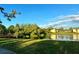 Beautiful lake with a walking bridge in a serene community with lush trees and sunny skies at 4005 Crockers Lake Blvd # 11, Sarasota, FL 34238