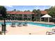 Inviting outdoor swimming pool with lounge chairs and tables under sunny skies near residential building at 4005 Crockers Lake Blvd # 11, Sarasota, FL 34238