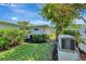 Backyard featuring lush landscaping with vibrant flowers, mature trees, and a well-maintained lawn at 405 Park N Blvd, Venice, FL 34285