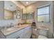 Well-lit bathroom featuring a double vanity, granite countertops, a medicine cabinet, and a shower at 405 Park N Blvd, Venice, FL 34285