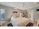 Bedroom with an ensuite bath, ceiling fan, and a sunlit window at 405 Park N Blvd, Venice, FL 34285