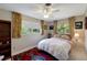 Cozy bedroom with an inviting bed, two windows with views, and a stylish red and blue area rug at 405 Park N Blvd, Venice, FL 34285