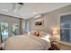 Bedroom with serene view to the outdoor pool and deck area, featuring a queen bed and light walls at 405 Park N Blvd, Venice, FL 34285