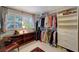 Walk-in closet with custom shelving, rods for hanging clothes, and a window at 405 Park N Blvd, Venice, FL 34285