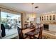 Elegant dining room with a chandelier, adjacent to a kitchen, perfect for entertaining guests at 405 Park N Blvd, Venice, FL 34285