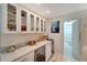 Stylish kitchen with white cabinets, wine cooler and granite countertops, offering a bright and organized space at 405 Park N Blvd, Venice, FL 34285