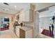 Bright kitchen featuring white cabinets, stone countertops, stainless steel appliances and a wine fridge at 405 Park N Blvd, Venice, FL 34285