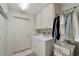 Functional laundry room featuring a washer and dryer, overhead cabinets, and a hanging rack for clothes at 405 Park N Blvd, Venice, FL 34285