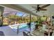 Enclosed pool area with tropical landscaping, seating, and shade from the Florida sun at 405 Park N Blvd, Venice, FL 34285