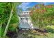 Backyard shed with double doors surrounded by lush landscaping at 405 Park N Blvd, Venice, FL 34285