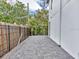 Side yard features paved patio, black fence, and lush landscaping at 4112 Swift Rd, Sarasota, FL 34231