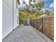 Backyard space with paved patio, black fence, and lush landscaping at 4112 Swift Rd, Sarasota, FL 34231