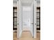 Elegant bathroom features a modern tub with an open shelving and white doors at 4112 Swift Rd, Sarasota, FL 34231