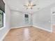 Bright bedroom with hardwood floors and a ceiling fan, with large windows offering natural light at 4112 Swift Rd, Sarasota, FL 34231