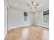Bedroom with hardwood floors, a ceiling fan and natural light from windows, creating a cozy space at 4112 Swift Rd, Sarasota, FL 34231