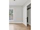 Bright bedroom features wood flooring, large windows, and closet with sliding doors at 4112 Swift Rd, Sarasota, FL 34231