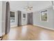 Bright bedroom featuring hardwood floors, neutral paint, and multiple windows with shades at 4112 Swift Rd, Sarasota, FL 34231