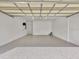Large garage space featuring gray epoxy flooring and ample lighting at 4112 Swift Rd, Sarasota, FL 34231