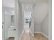 Hallway featuring marble tile flooring, access to full bathroom, and stair access at 4112 Swift Rd, Sarasota, FL 34231