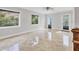 Large, sunlit living space with tile flooring, contemporary fixtures, and views of the outdoor scenery at 4112 Swift Rd, Sarasota, FL 34231