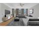 Contemporary living room with plush gray carpeting, a large sectional sofa, and bright windows at 4112 Swift Rd, Sarasota, FL 34231