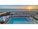 Aerial view of the pool and beach during sunset at 4651 Gulf Of Mexico Dr # 304, Longboat Key, FL 34228