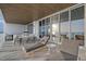 Spacious covered balcony featuring lounge chairs and outdoor dining with breathtaking ocean vistas at 4651 Gulf Of Mexico Dr # 304, Longboat Key, FL 34228