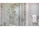 Stylish bathroom featuring a glass shower, marble wall and floor tiles, and modern fixtures at 4651 Gulf Of Mexico Dr # 304, Longboat Key, FL 34228