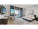 Bright bedroom with a balcony overlooking a picturesque view, a sitting area, and contemporary furnishings at 4651 Gulf Of Mexico Dr # 304, Longboat Key, FL 34228
