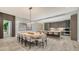 Elegant dining room featuring a long table, seating for ten, and an open floor plan to the kitchen at 4651 Gulf Of Mexico Dr # 304, Longboat Key, FL 34228
