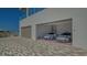 Bright two-car garage of home with patterned brick driveway, and gated yard at 4651 Gulf Of Mexico Dr # 304, Longboat Key, FL 34228