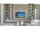 Modern living room with custom shelving, cabinets, and media center, enhancing both style and functionality at 4651 Gulf Of Mexico Dr # 304, Longboat Key, FL 34228