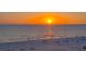 Stunning ocean view at sunset with people walking along the sandy beach at 4651 Gulf Of Mexico Dr # 304, Longboat Key, FL 34228
