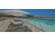 Resort-style pool with sun loungers offers a luxurious beachfront experience at 4651 Gulf Of Mexico Dr # 304, Longboat Key, FL 34228