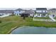 Large green backyard with a screened in porch that backs up to a pond at 4767 Reisswood Loop, Palmetto, FL 34221