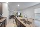 Open kitchen with granite countertops, large sink, and breakfast bar overlooking the living area at 4767 Reisswood Loop, Palmetto, FL 34221