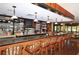 A stylish bar area featuring granite countertops, pendant lighting, wood floors, and an array of beverages at 5458 Golf Pointe Dr, Sarasota, FL 34243