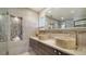 Modern bathroom featuring dual stone vessel sinks, unique tile, and sleek vanity at 5458 Golf Pointe Dr, Sarasota, FL 34243