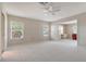 Carpeted bedroom with built in desk, 2 large windows and neutral colored walls at 5458 Golf Pointe Dr, Sarasota, FL 34243