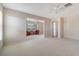 Spacious carpeted bedroom with attached sitting room; neutral paint and ceiling fan at 5458 Golf Pointe Dr, Sarasota, FL 34243
