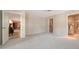 Large carpeted room with access to bathroom, closet and other living areas at 5458 Golf Pointe Dr, Sarasota, FL 34243