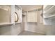Walk-in closet with custom shelving and plenty of space for storage; carpeted flooring at 5458 Golf Pointe Dr, Sarasota, FL 34243