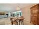 Open dining room includes elegant chandelier and access to the living room at 5458 Golf Pointe Dr, Sarasota, FL 34243
