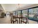 Elegant dining room boasts beautiful backyard view and stone fireplace at 5458 Golf Pointe Dr, Sarasota, FL 34243