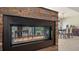 Modern fireplace features stone surround and clear view to outdoor space at 5458 Golf Pointe Dr, Sarasota, FL 34243