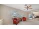 Cozy living room features ceiling fan and view of the backyard at 5458 Golf Pointe Dr, Sarasota, FL 34243