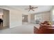 Living room offers natural light, ceiling fan, and built-in bookshelves at 5458 Golf Pointe Dr, Sarasota, FL 34243