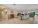 Open-concept living room with stone fireplace and abundant natural light at 5458 Golf Pointe Dr, Sarasota, FL 34243